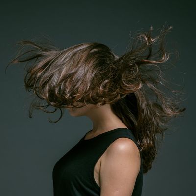 Side view of a person in a balanced, flowing motion pose.