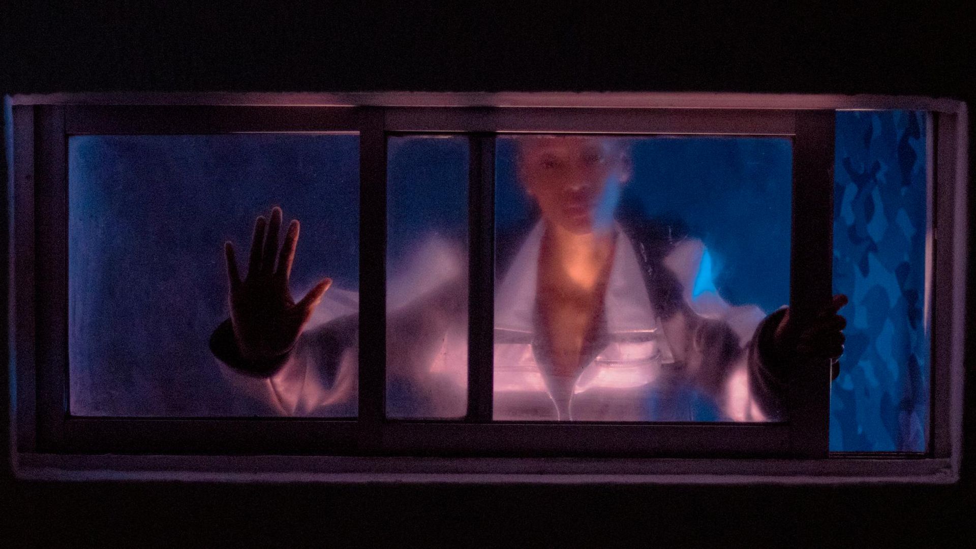 Silhouette of a person in a dynamic, flowing pose against a dark, atmospheric background.